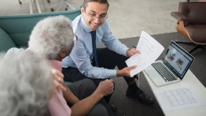 Financial advisor helping an elderly couple finalize their retirement planning