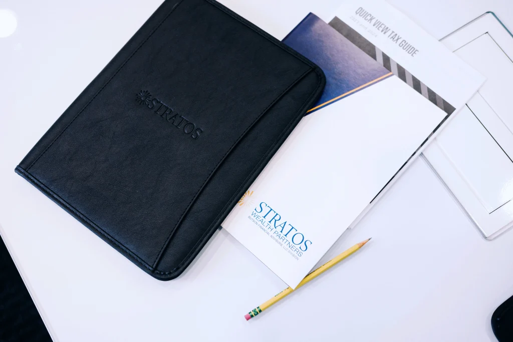 Stratos Wealth Partners notebook and folder sitting on table